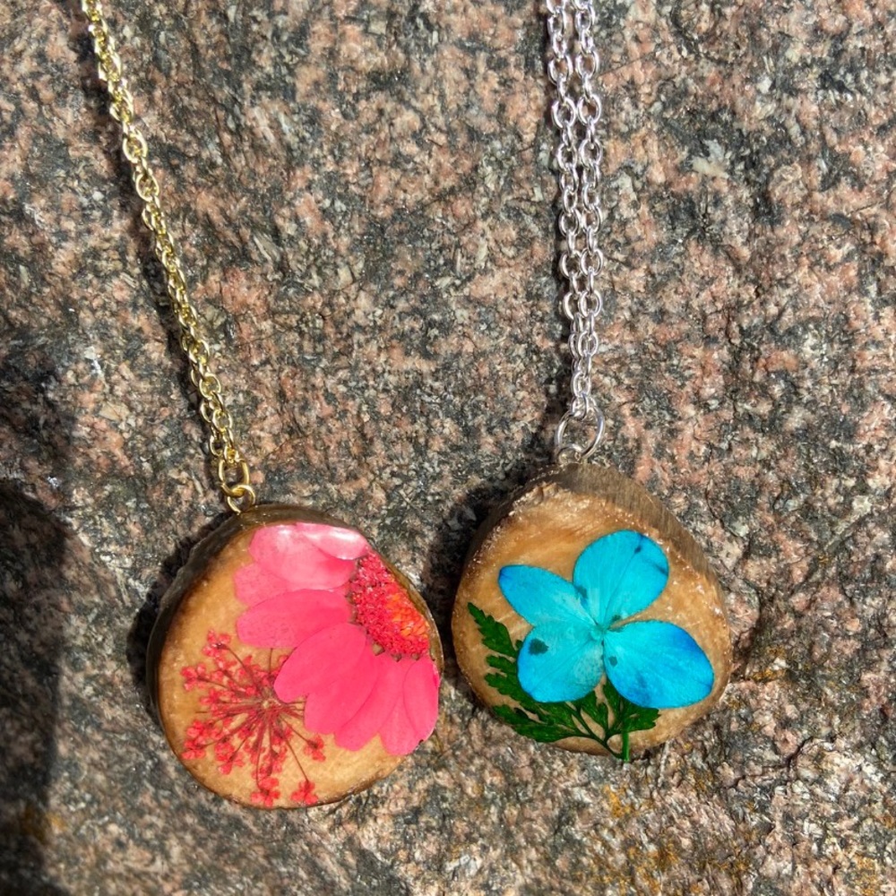 Wooden pressed flower charm necklaces.